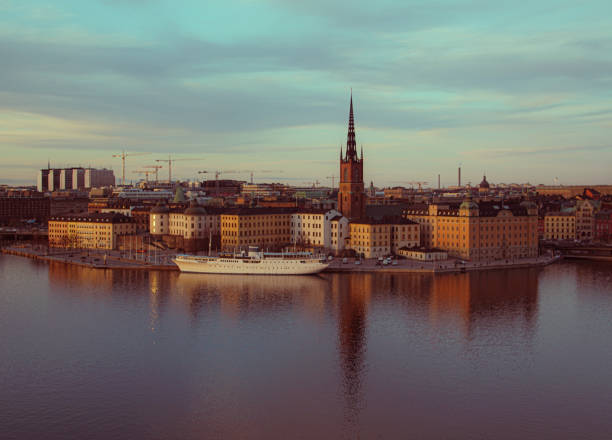 istock View of buildings at waterfront against cloudy sky 1986433239
