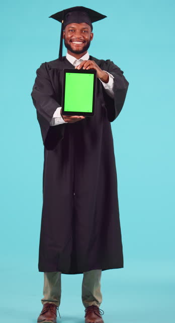 University, graduation and green screen on a tablet with a student black man in studio on a blue background. Portrait, application and chromakey on an empty display with a male university graduate