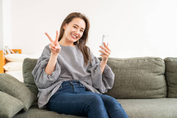 istock attractive Asian woman using a smart phone 1986453076