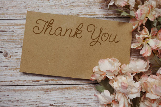 istock Thank You typography text with flowers frame on wooden background 1986486842
