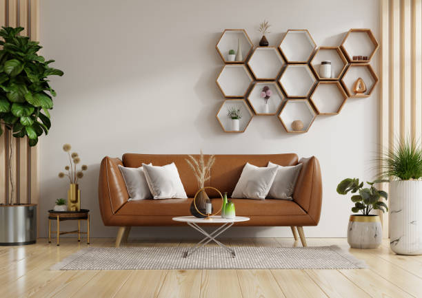 istock Living room wall mockup with leather sofa and decor on white background 1986491596