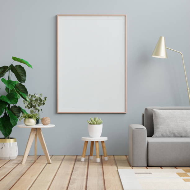 istock Poster mockup with vertical frames on empty dark blue wall in living room interior with gray velvet sofa 1986492550