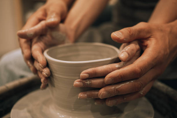istock Couple mold ceramic vase in a pottery workshop, hands close up. 1986510976