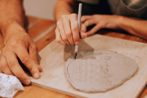 istock A young couple is engaged in creativity in a pottery workshop. Hands close up. 1986511508