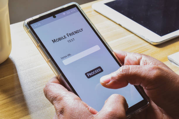 istock Person testing mobile friendliness tool to analyse the look and performance of his website on a mobile device. 1986519347