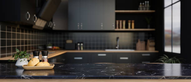 A space for displaying your product on a black marble kitchen countertop in a modern black kitchen. A space for displaying your product on a luxury black marble kitchen countertop in a modern black kitchen with kitchen appliances. 3d render, 3d illustration kitchen island stock pictures, royalty-free photos & images