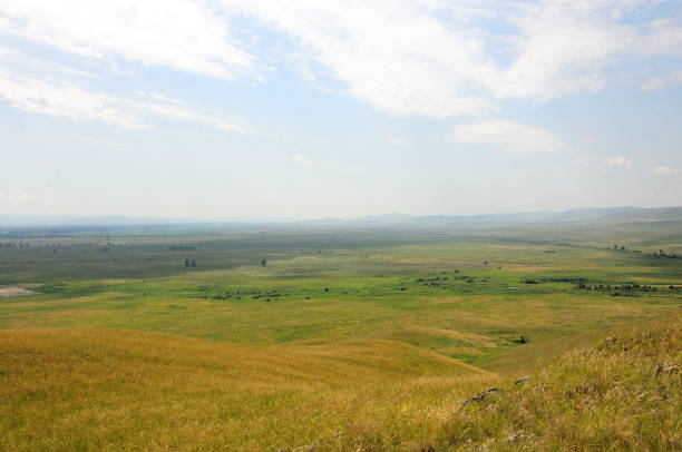 istock Endless hilly steppe with low, yellowed grass under a cloudy summer sky. 1986545266