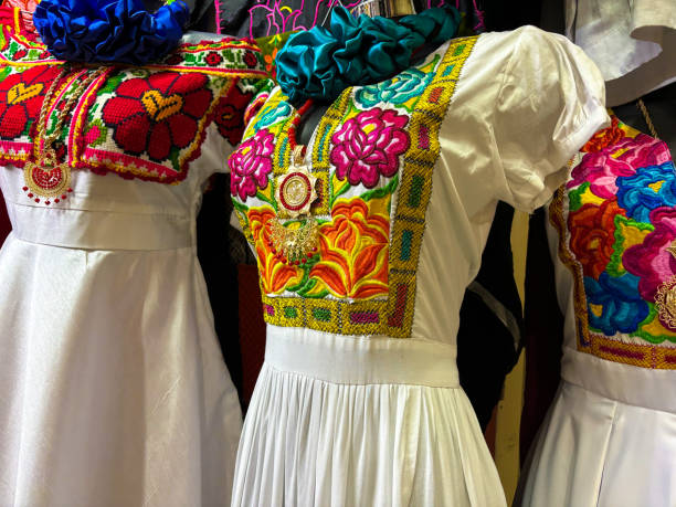 oaxaca, mexico: colorful embroidered dresses at market - mexico dress market clothing imagens e fotografias de stock