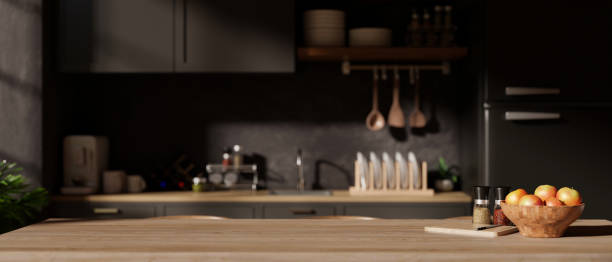 istock A copy space on a hardwood dining table in a modern black kitchen with kitchen appliances. 1986552920