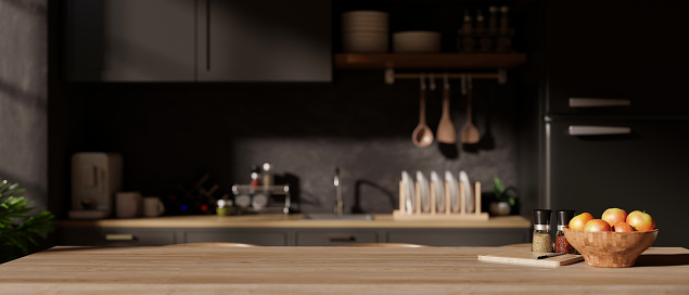 A copy space on a hardwood dining table or kitchen island in a modern black kitchen with kitchen appliances. front view image. 3d render, 3d illustration