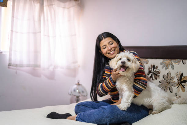 istock Latin woman playing with her dog 1986581087