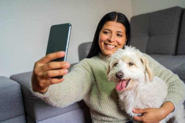 istock Latin woman taking a selfie with her dog 1986581618