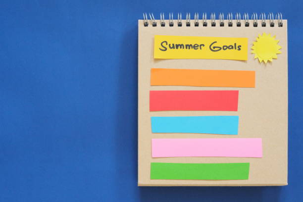 istock Summer goals concept. Checklist of goals in note pad in blue background with copy space. 1986591734