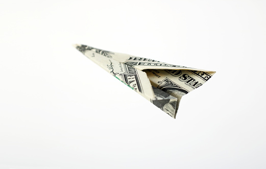 Paper airplane from the dollars.Concept for travel, business idea, leadership, success, teamwork, creative idea, vision