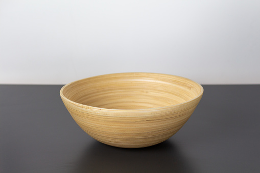 Photograph of a bowl made of bamboo on a gray kitchen counter.