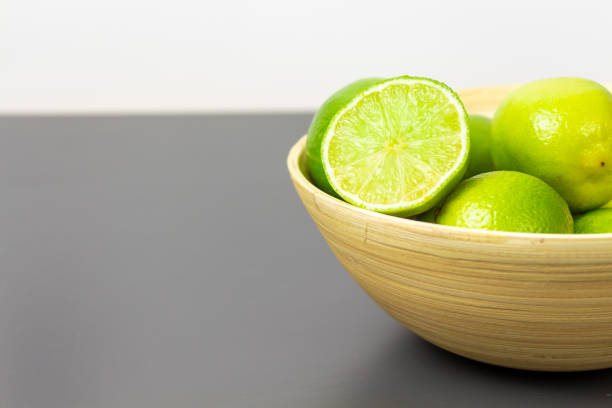 istock Natural fresh limes in a bowl, with copy space. 1986606134