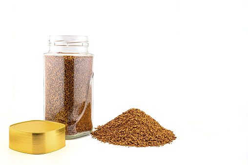 Side view of a can of instant freeze-dried coffee roasted to a golden hue with a gold lid close up on a white background