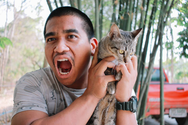 happy man playing with his cat