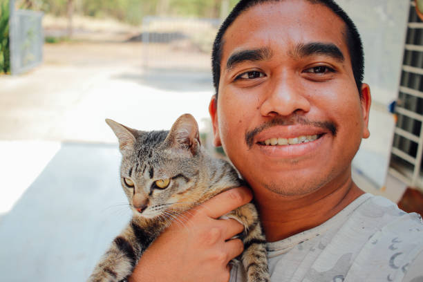 istock happy man playing with his cat 1986678730