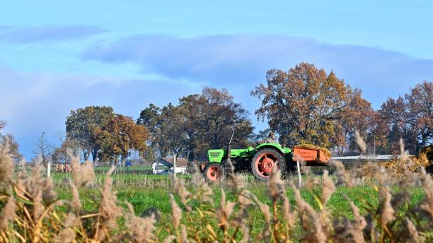Autumn is coming again.\nThe autumn fields are scented with earth.\nApproaching the fields, you can enjoy the beauty of late autumn.\nThis is a view of the countryside outside Geneva.\nRural scene  in late autumn-Working tractor.