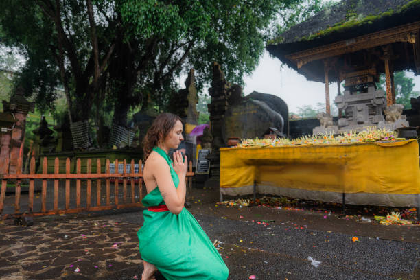 Woman doing purifying ritual in  Tirta Empul holy spring in Ubud, Bali, Indonesia
