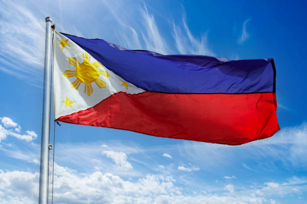 istock Philippine Flag isolated against a blue sky on windy day 1986761044