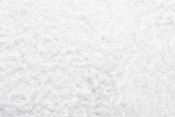 istock White shower towel texture. Fluffy carpet background. Blank bathroom textile 1986766789
