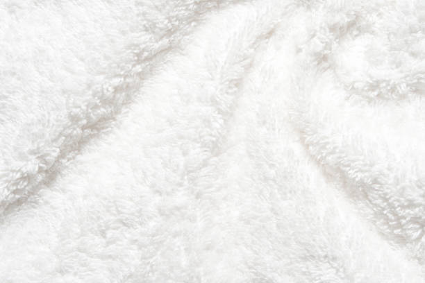istock White shower towel texture. Fluffy carpet background. Blank bathroom textile 1986766794