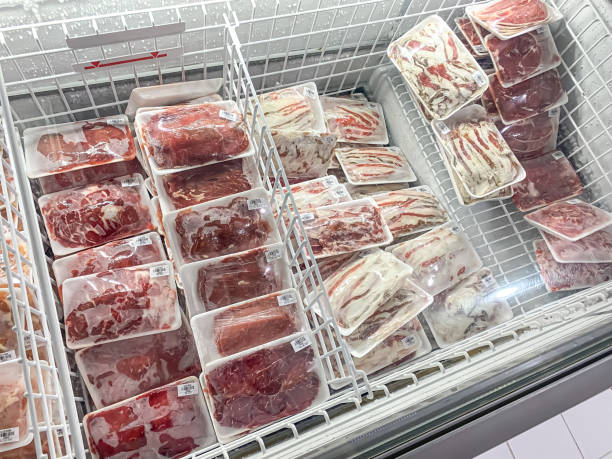 Display case and refrigerator in a Indonesian butcher shop stocking various packaged cuts of meat, offal, minced and sliced. Natural whole healthy food, animal protein, essential amino acid concept.