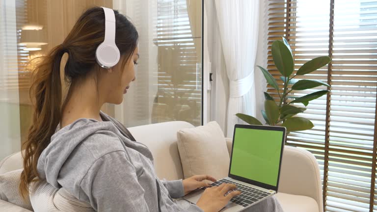 Empty Green Screen laptop Blogger Woman hands typing Laptop computer keyboard. Close up women hands using laptop sitting sofa living room. Freelance women work from home office video call conference