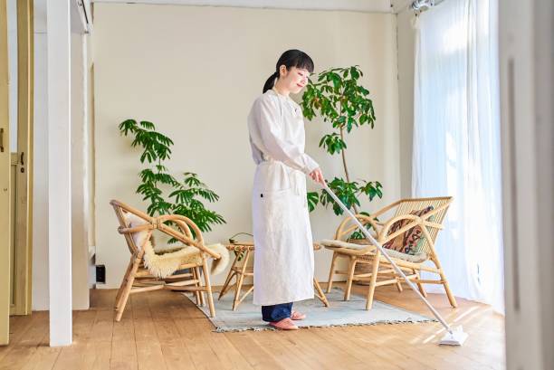 istock Young woman cleaning the flooring 1986801319