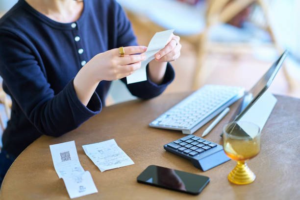 istock young woman holding a receipt 1986825213