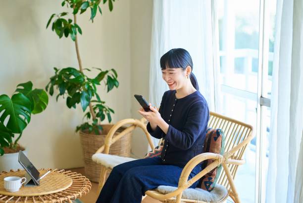 istock Young woman operating a smartphone 1986828819