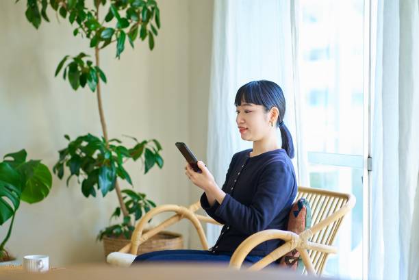 istock Young woman operating a smartphone 1986829847
