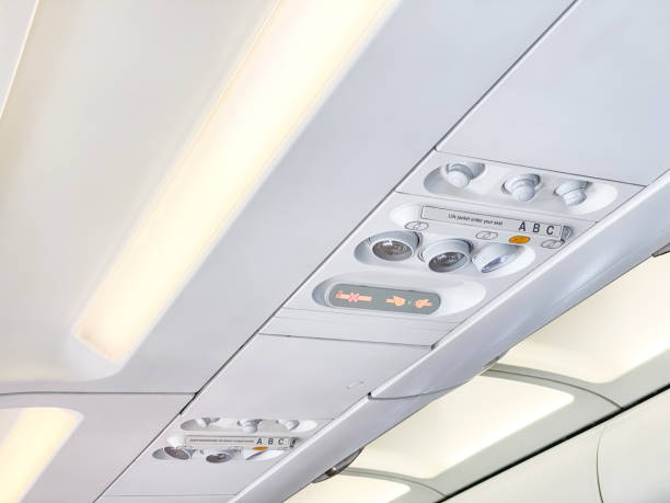 istock The cabin ceiling of the plane with AC control dial, reading lamp light and flight attendant calling button. Airplane interior in plane corridor. 1986836550