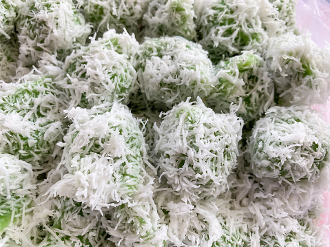 Klepon is a typical Indonesian sweet steamed cake, made from sticky rice flour and filled with brown sugar. Balinese Klepon sprinkled with grated coconut flesh.
