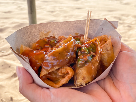 Balinese Lumpia or spring rolls served with garlic sauce and chopped chili are usually sold on the beach
