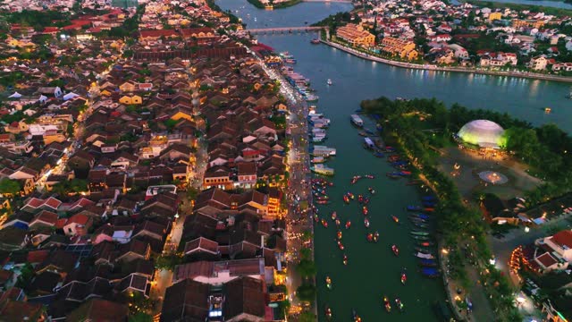 Aerial 4K drone footage of Hoi An city, Vietnam with many boats and An Hoi bridge