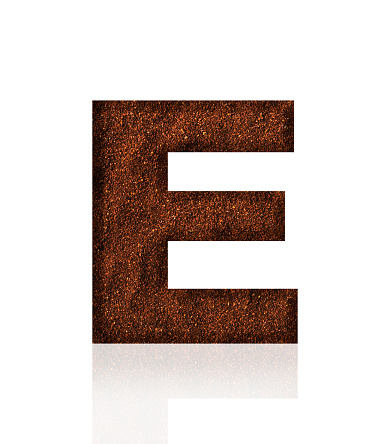 Close-up of three-dimensional grind coffee bean alphabet letter E on white background.