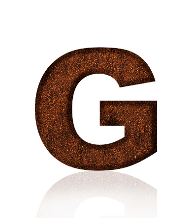 Close-up of three-dimensional grind coffee bean alphabet letter G on white background.