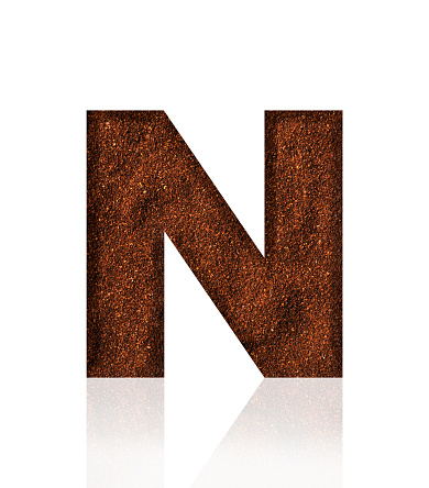 Close-up of three-dimensional grind coffee bean alphabet letter N on white background.