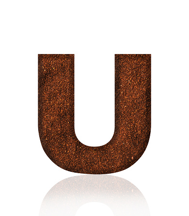 Close-up of three-dimensional grind coffee bean alphabet letter U on white background.
