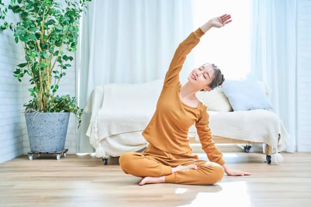 istock Young woman stretching in the room 1986903459