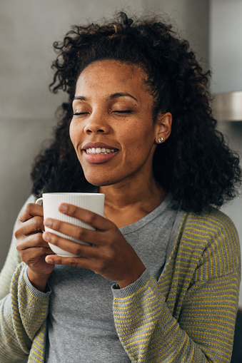 A beautiful multiracial woman enjoys her dink in peace.