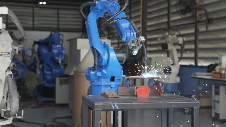 Automation robotic arm welding metal in factory : slow motion