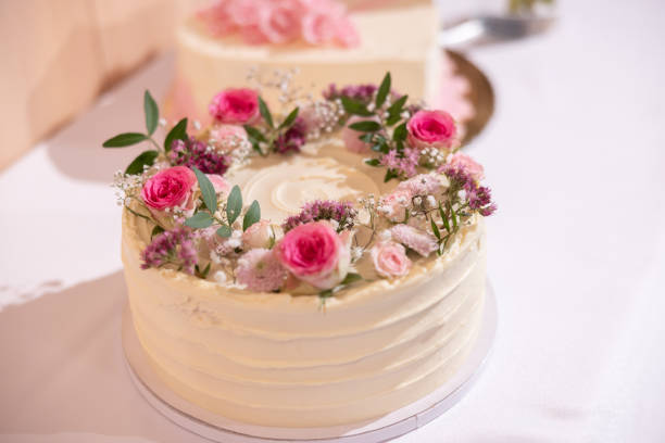 istock Wedding cake with red marzipan roses on the wedding table. 1986930671