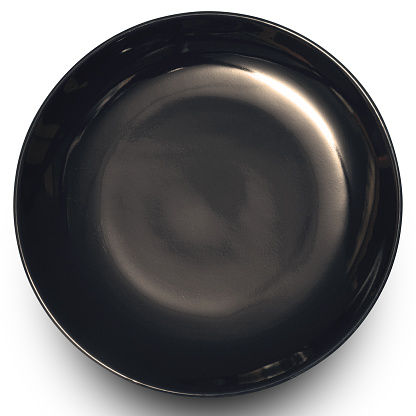 Empty black circle ceramics plate isolated on white background with clipping path.