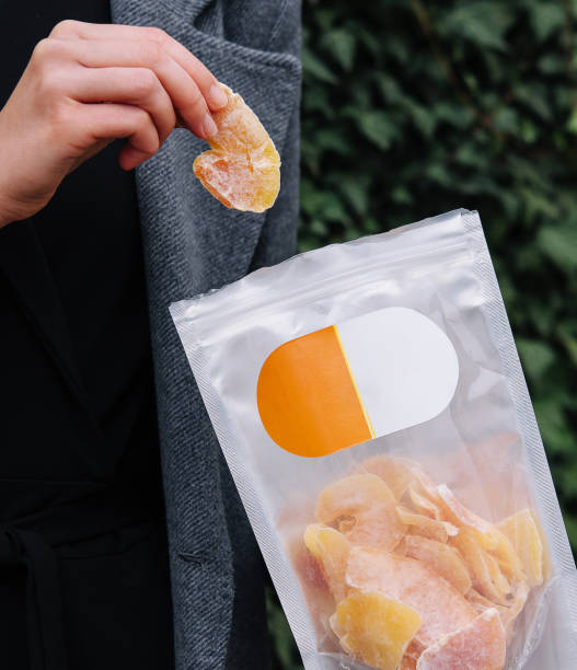 istock Girl Eating Dried Mango Slices 1986974429