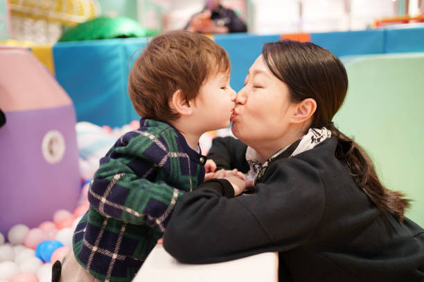 istock little boy kissing mother 1986986646