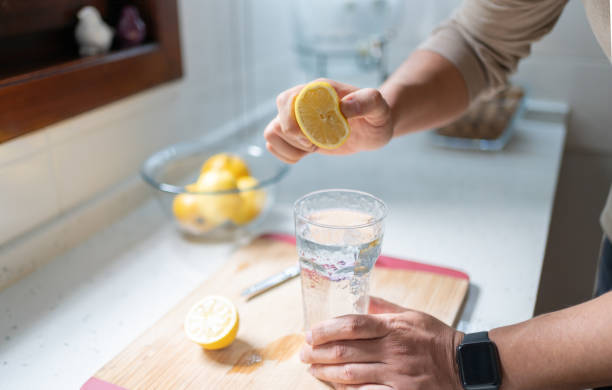 istock Man Squeezing Out Juice Of Lemon 1986986650